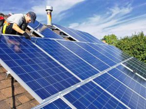 contractor installing solar panels on residential roof