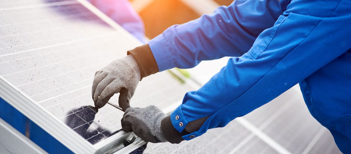 man installing solar panels